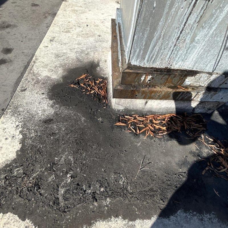 Commercial roof flashing with rust and debris buildup