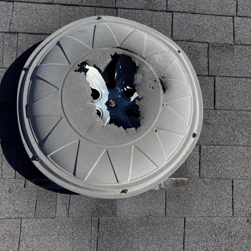 Roof vent cover with severe damage on asphalt shingles