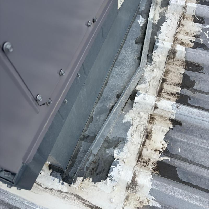 Metal roof flashing with sealant on commercial roof panel Metal roof flashing with sealant on commercial roof panel