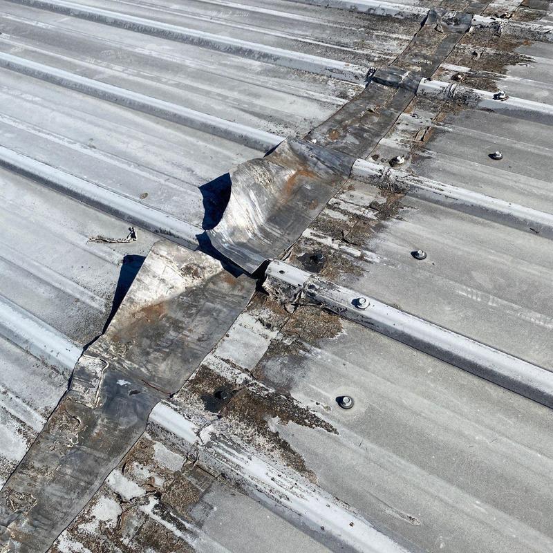 Metal roof flashing with rust and damage