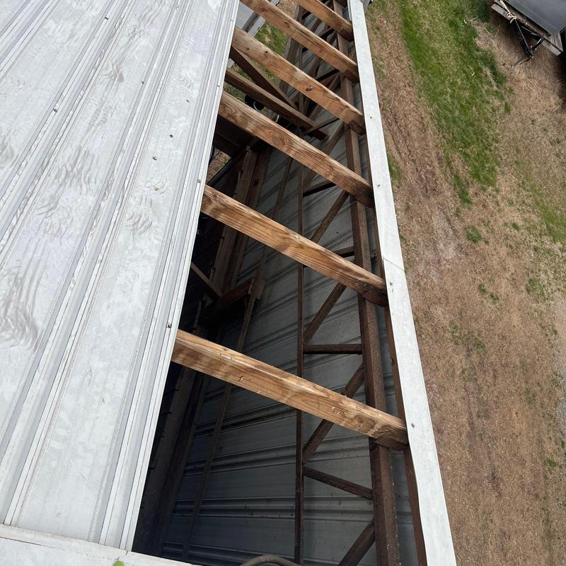 Metal roof panel and wooden roof framing inspection