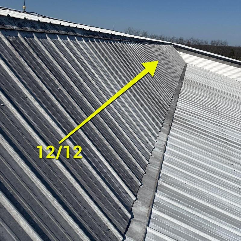 Metal roofing panels with highlighted ridge slope