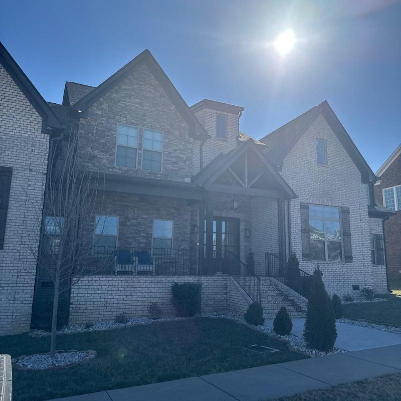 Asphalt shingle roof with hail damage under bright sun