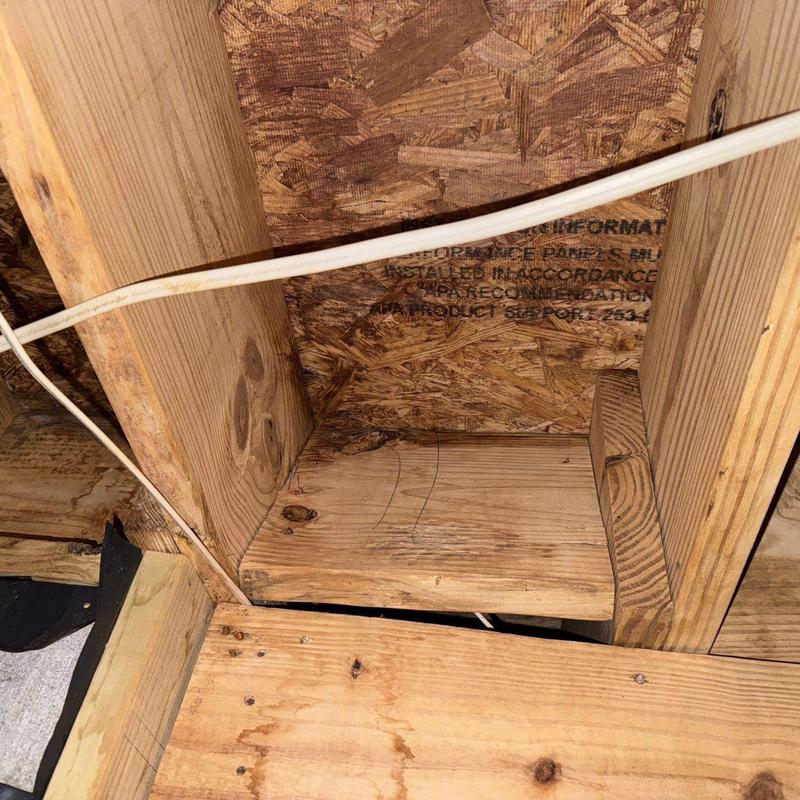 Wooden joists and wiring in attic framing structure