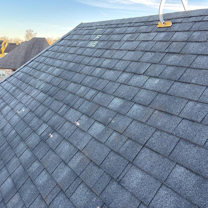 Asphalt shingles with hail damage on roof slope