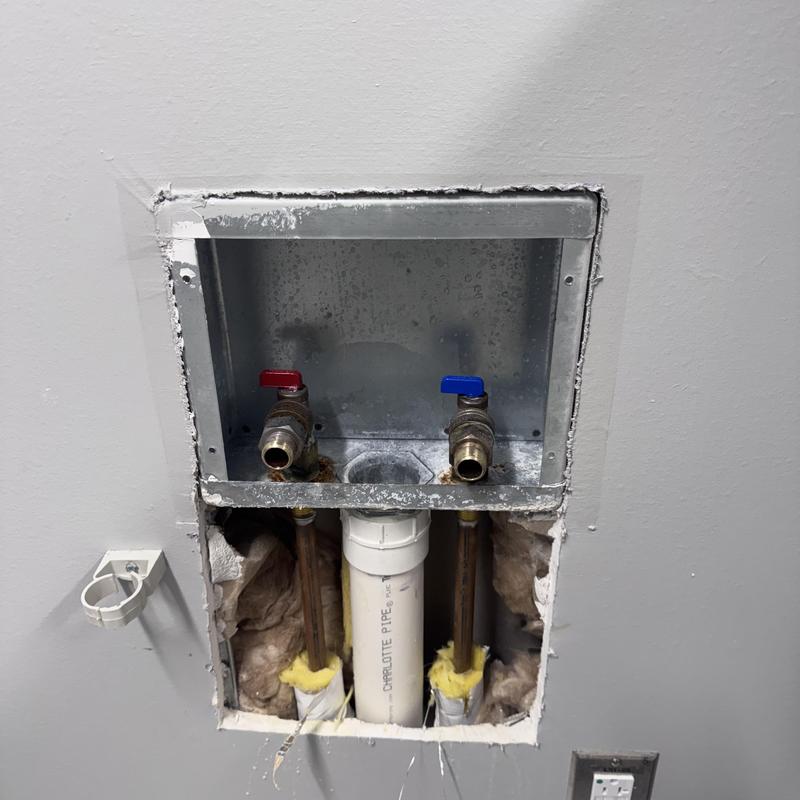 Laundry box with water valves and drain pipe exposed