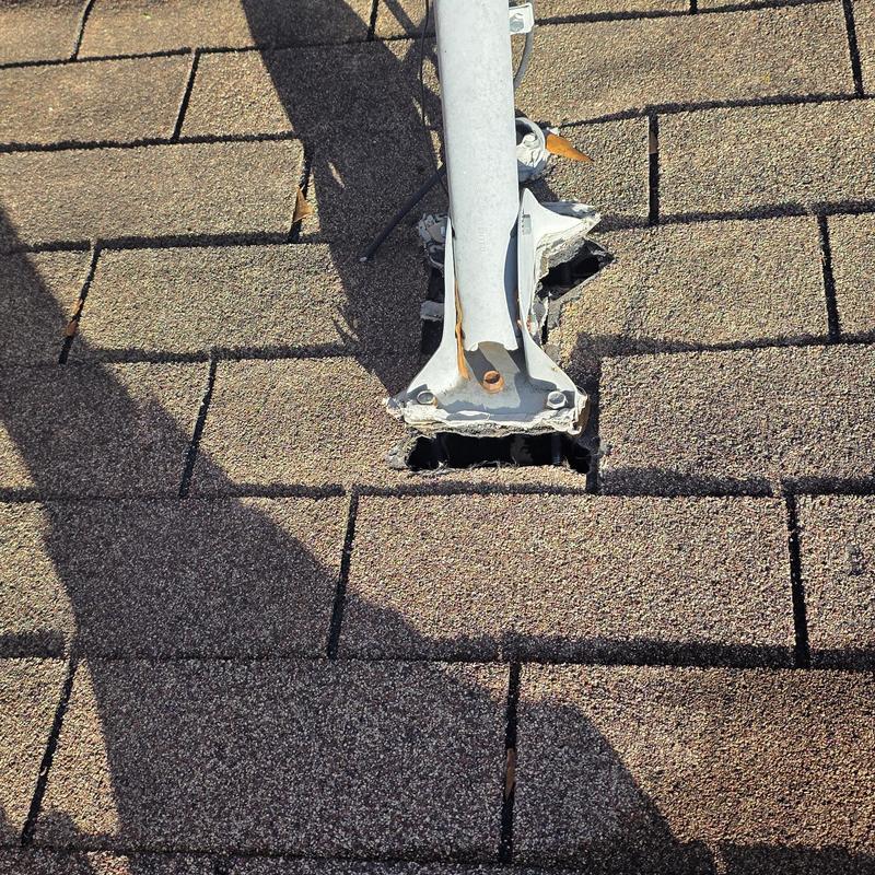 Roof shingles with hail damage around mount base