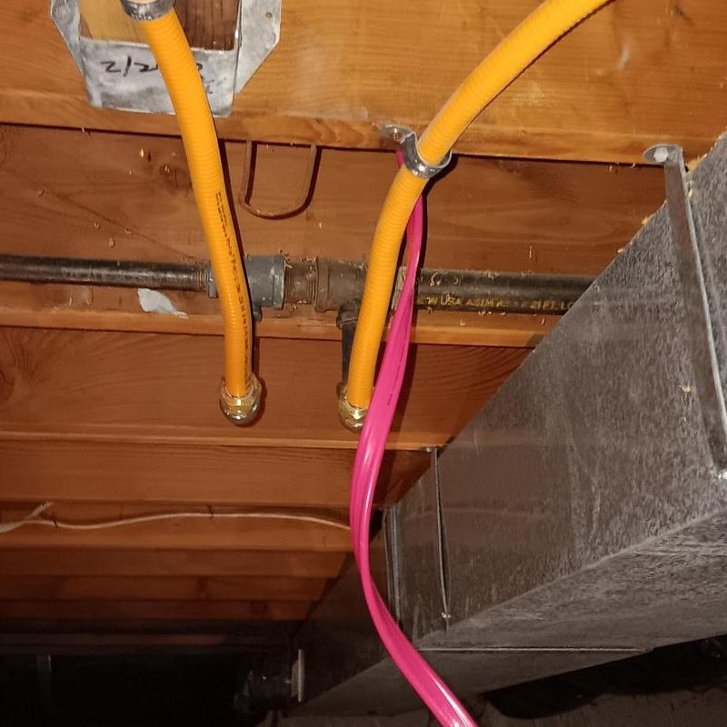 Gas and water lines installation under floor joists