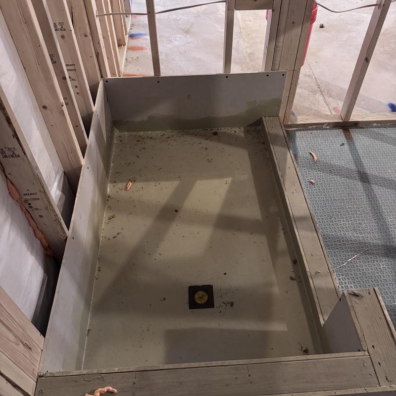 Shower base rough plumbing with drain installation