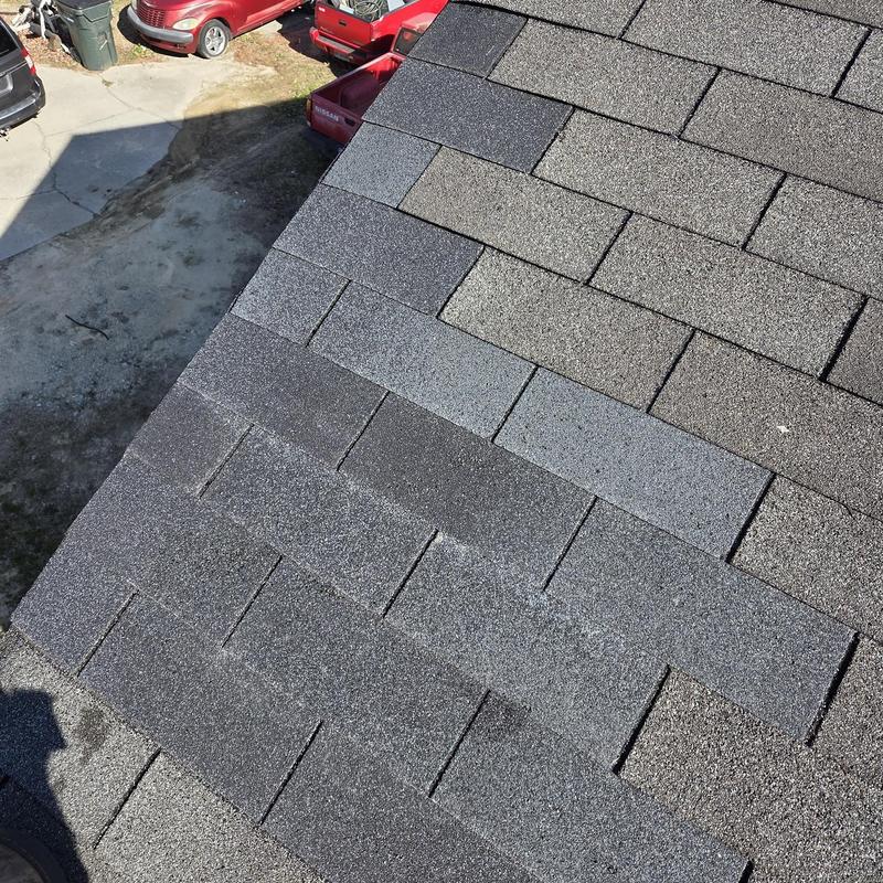Asphalt shingle roof with repaired damaged shingles