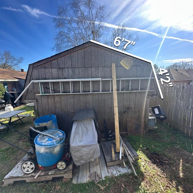 Shed exterior wall with measurements and tools Shed exterior wall with measurements and tools