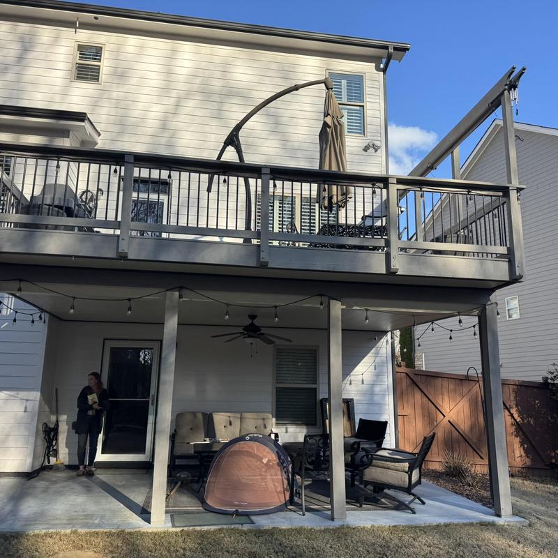 Wooden deck and railing inspection with furniture and canopy