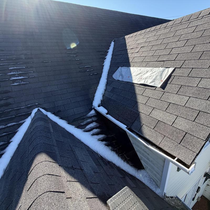 Slate 3-tab roof with tarp over missing shingles
