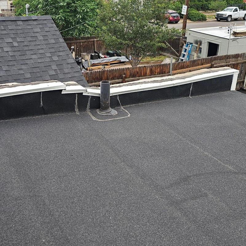 Modified bitumen flat roof with damaged parapet wall Modified bitumen flat roof with damaged parapet wall