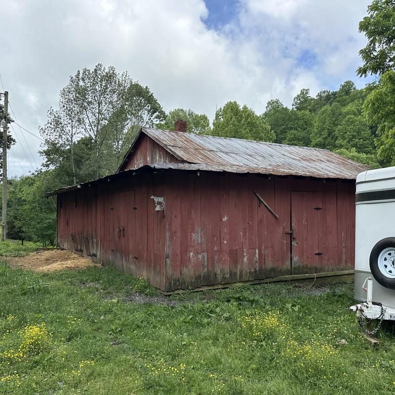 Metal roof on old red barn in rural farm setting