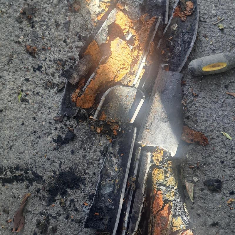 Sewer drain pipe section removed on asphalt ground