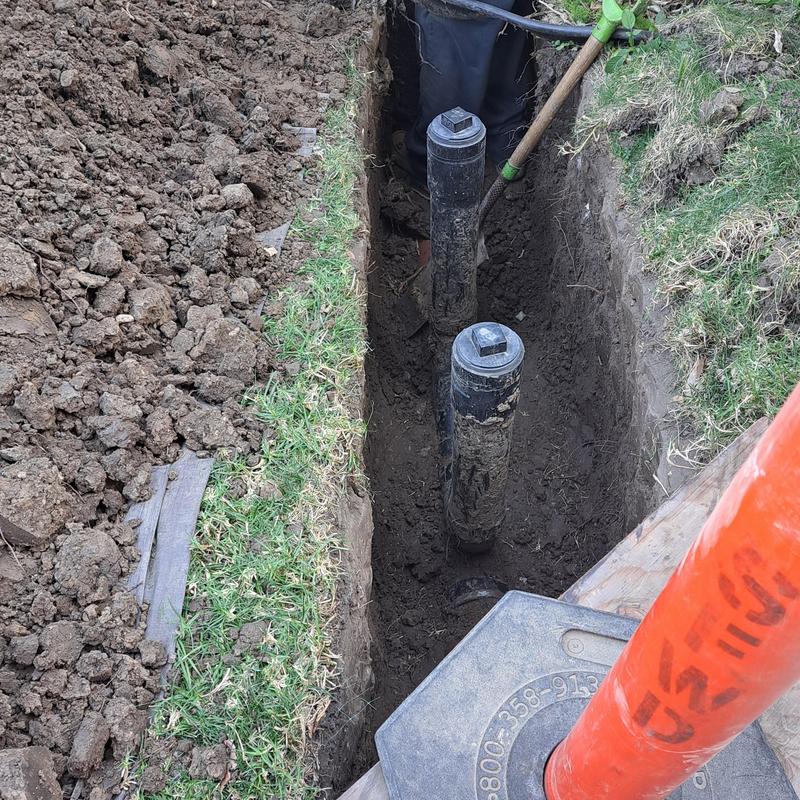 Sewer drain pipes installation in trench with tools