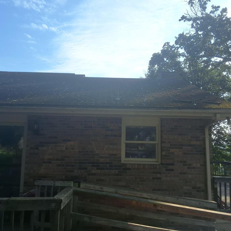Roof shingles in Weathered Wood color on brick house