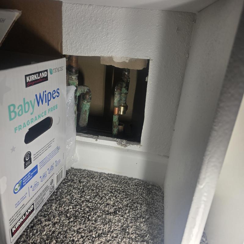 Copper manifold hot water line leak capped inside wall cavity