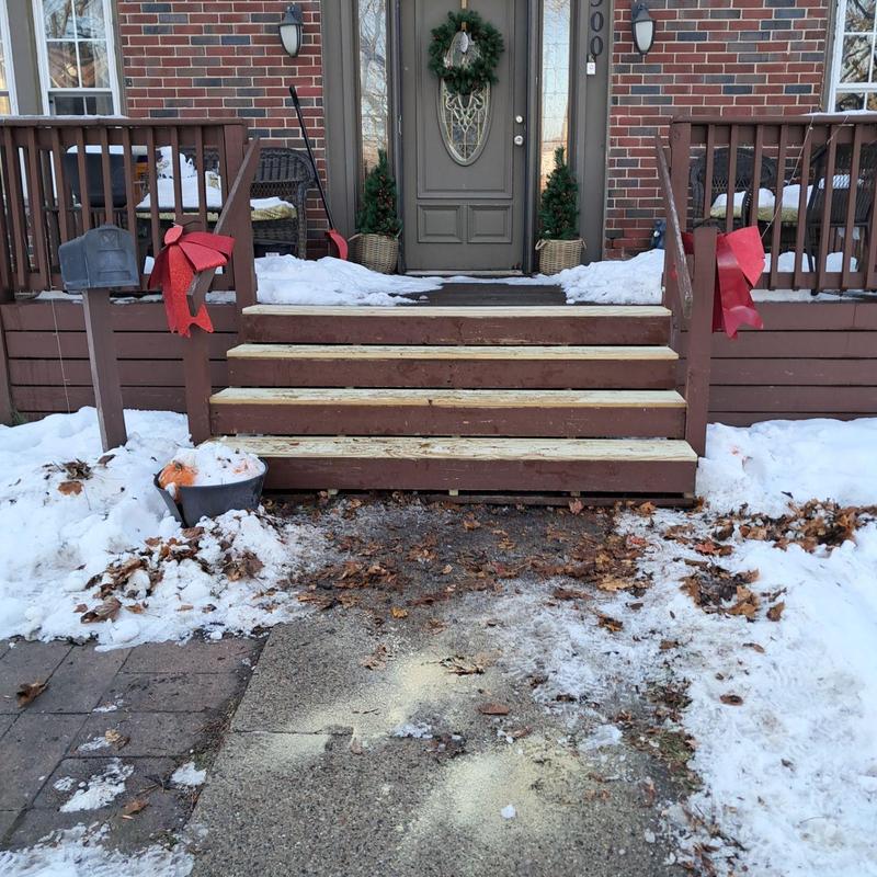 Exterior wooden deck stairs with snow surrounding Exterior wooden deck stairs with snow surrounding