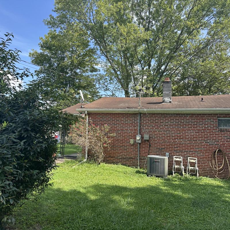 Black Shadow shingles with chimney on brick house