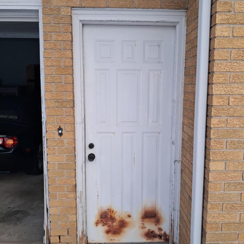 Exterior door with rust and frame damage Exterior door with rust and frame damage
