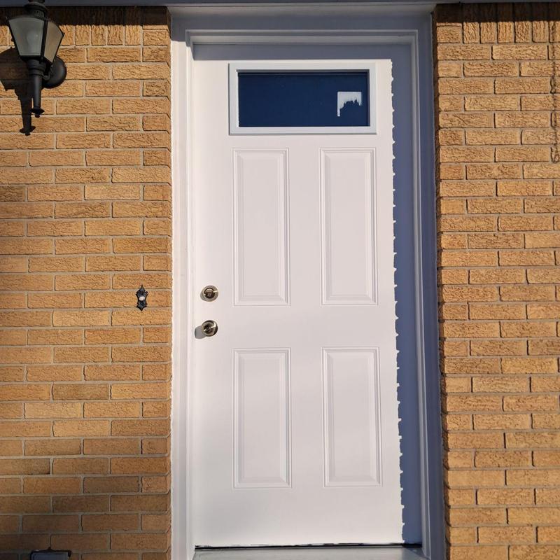 Exterior door replacement with window panel in brick wall Exterior door replacement with window panel in brick wall