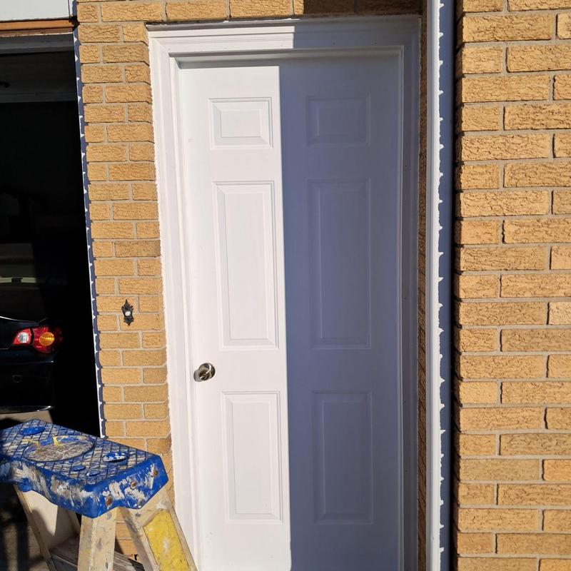 Exterior door with new frame installation in brick wall Exterior door with new frame installation in brick wall