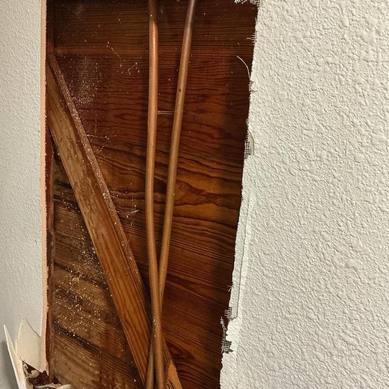 Copper water pipes inside wall with freeze break damage