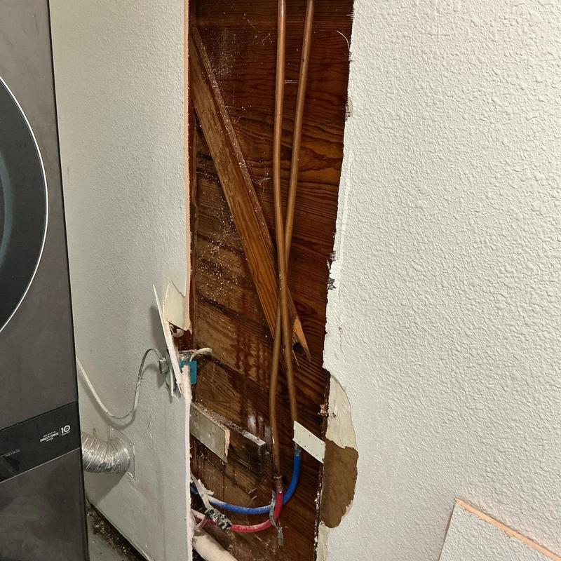 Copper water pipes inside wall with freeze break damage