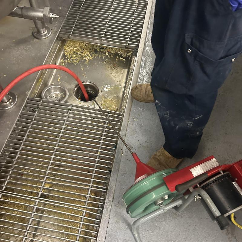 Commercial sink drain snaking for grease clog removal