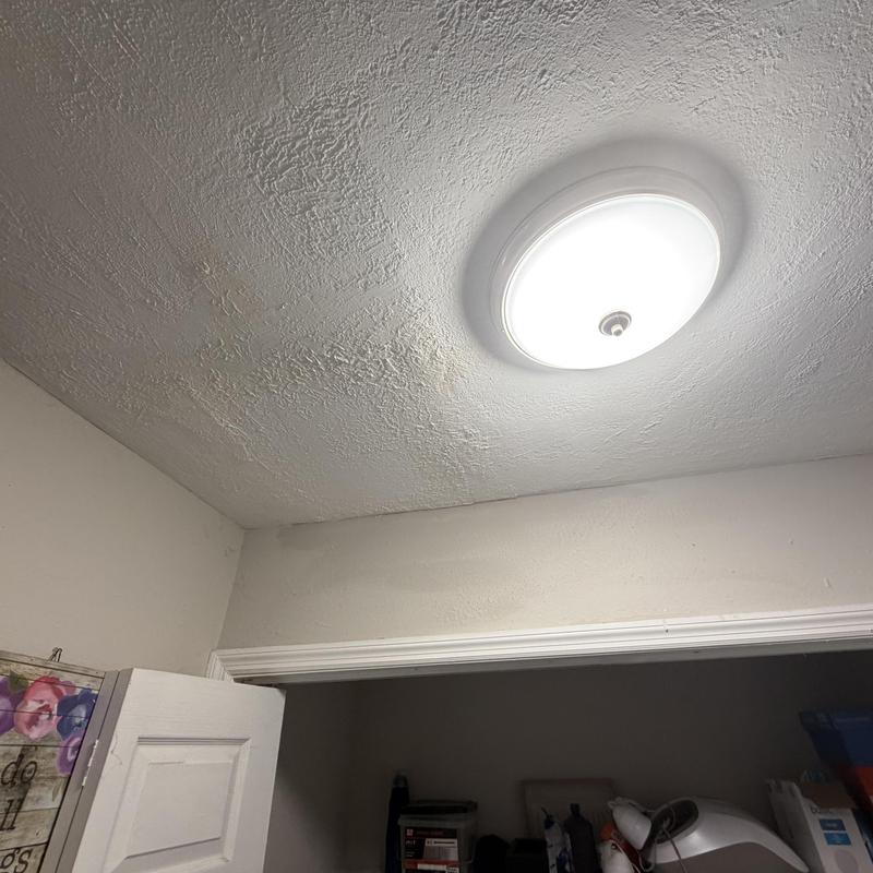 Bathroom ceiling with water damage near light fixture