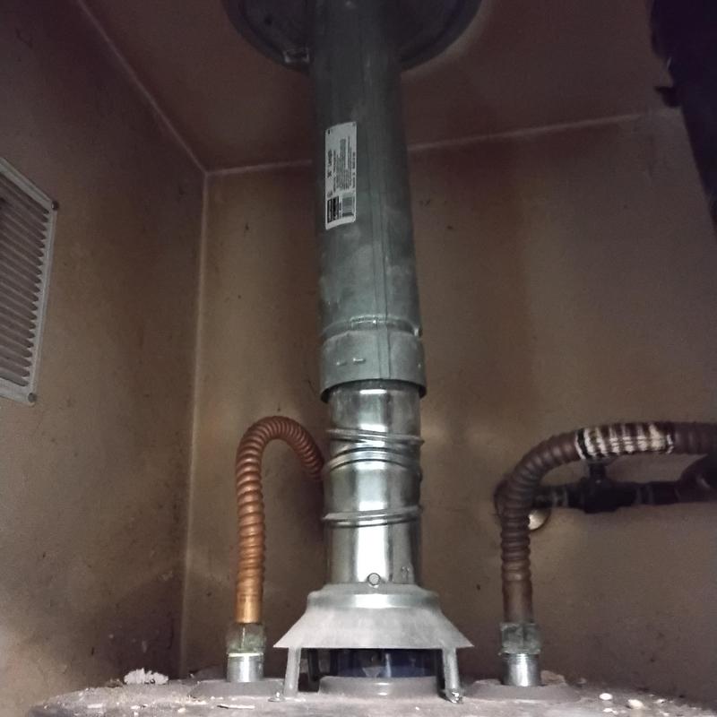 50 gallon gas water heater with vent pipe and gas lines