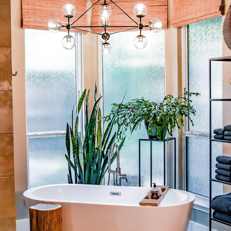 Freestanding tub with plants and natural light