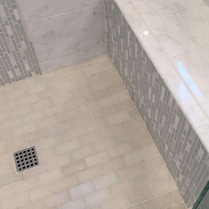 Master shower floor and tiled bench with marble top