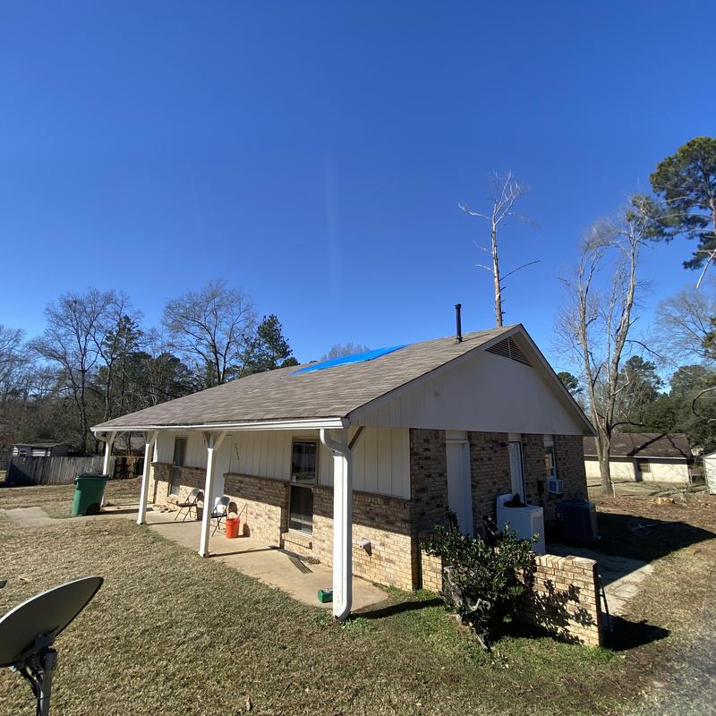 Roof with blue tarp covering tree damage in Florence, MS Roof with blue tarp covering tree damage in Florence, MS