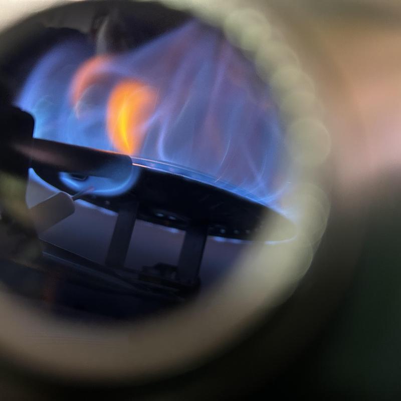 Water heater burner flame inside combustion chamber