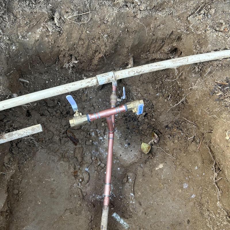 Copper water line with new ball valves installed in trench