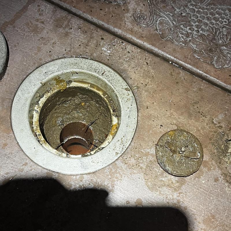 Main drain pipe clog with removed cover in floor