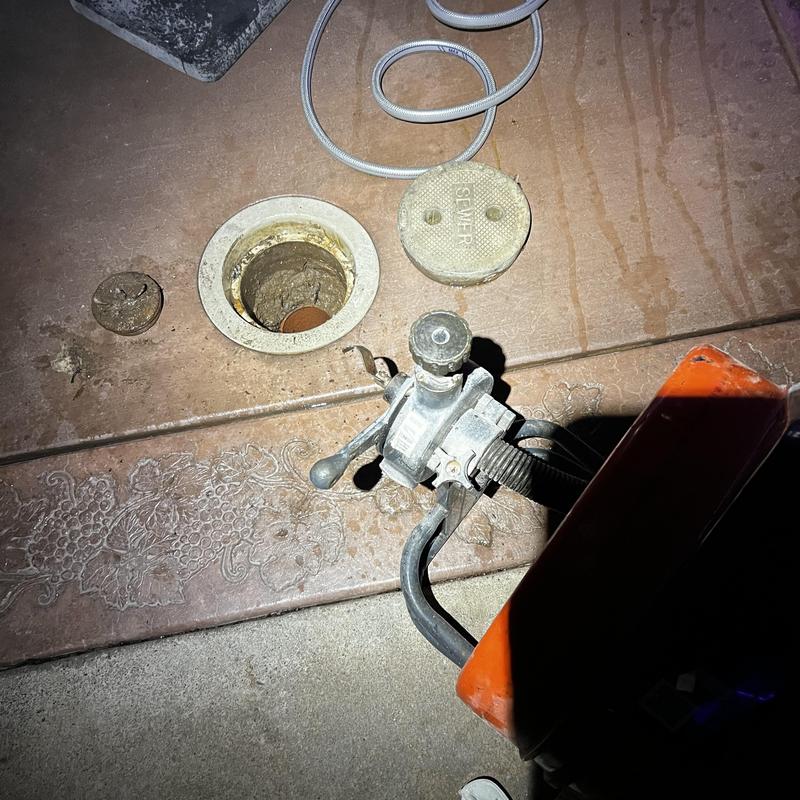 Main drain with drain cleaning machine in use