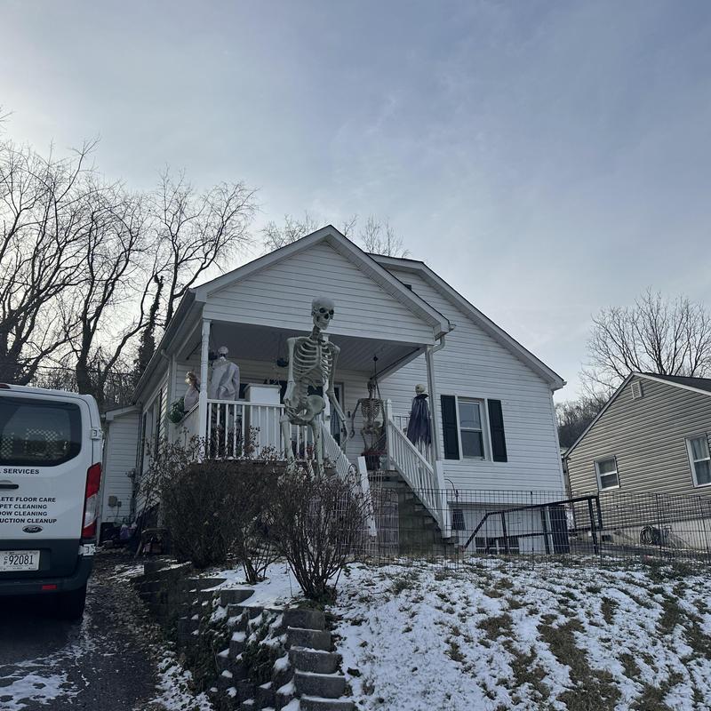 Roof shingles replacement on white house with porch