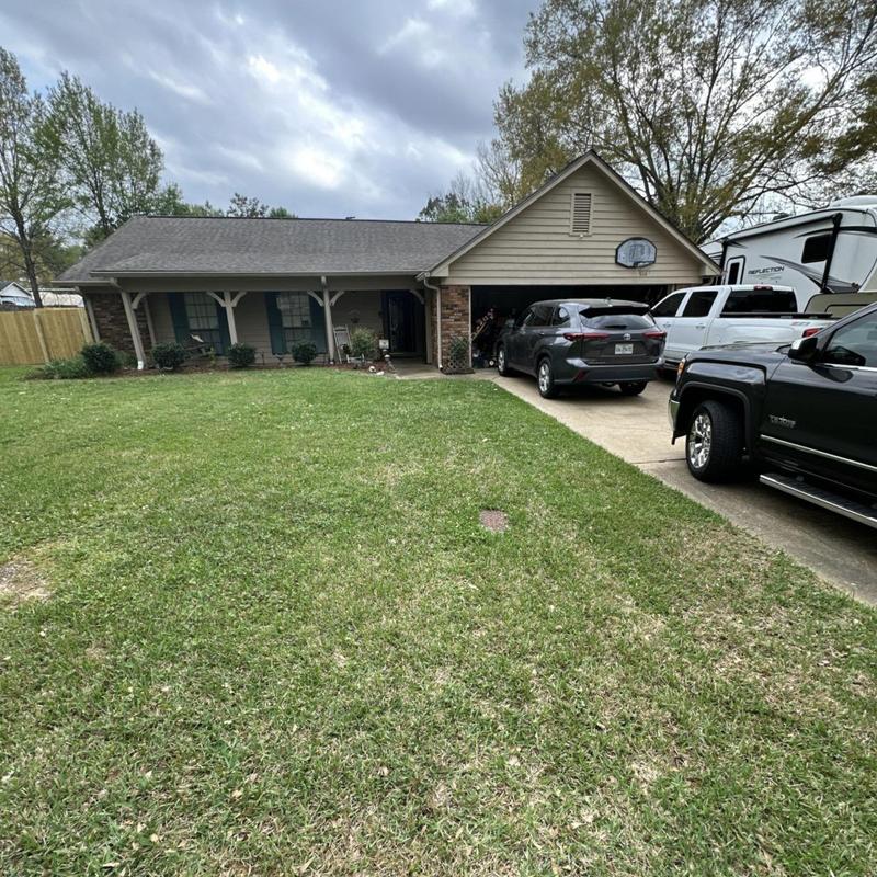 Asphalt shingle roof on suburban house with driveway cars Asphalt shingle roof on suburban house with driveway cars