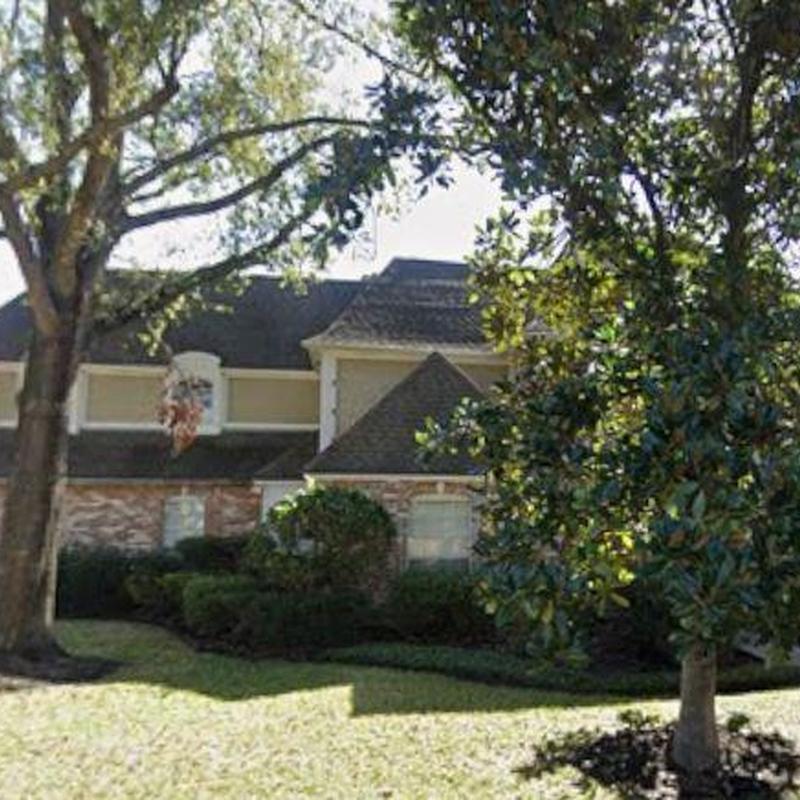 Residential roof with trees and lawn in Katy, TX