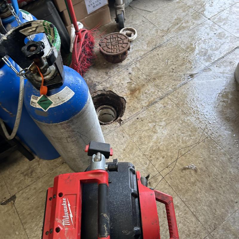 Sewer pipe jetting equipment near cleanout opening