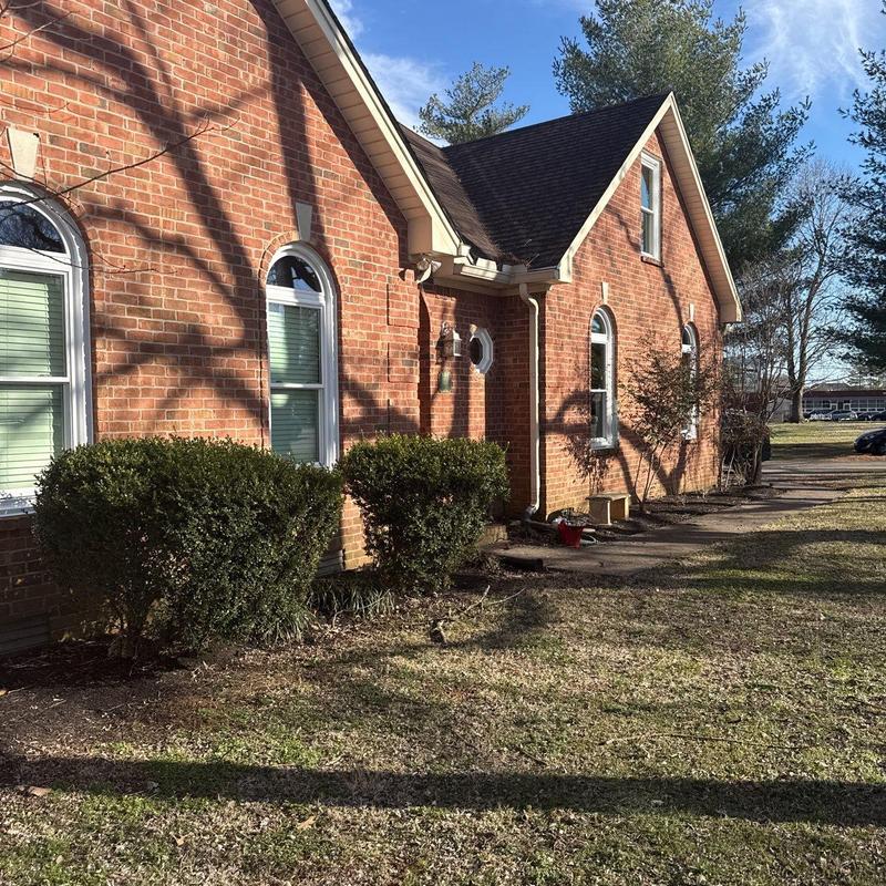 Asphalt shingle roof with ridge caps and flashing seals