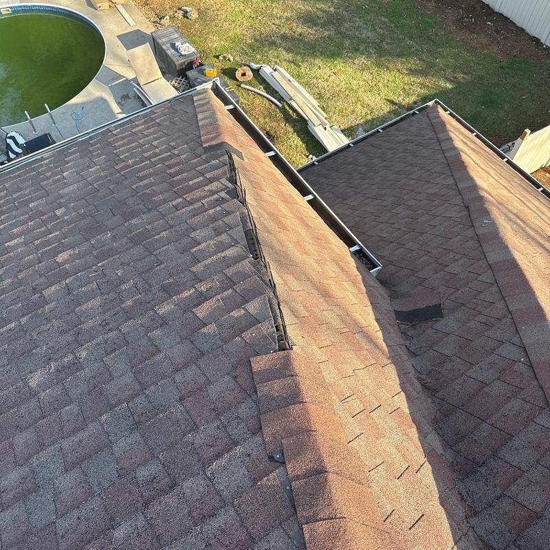 Asphalt shingle roof with hail damage and missing ridge caps