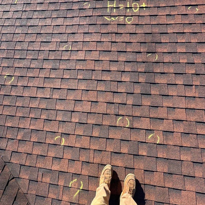 Roof shingles with hail damage marked in chalk