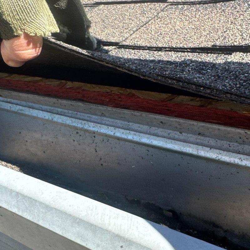 Asphalt shingle lifting inspection near metal flashing