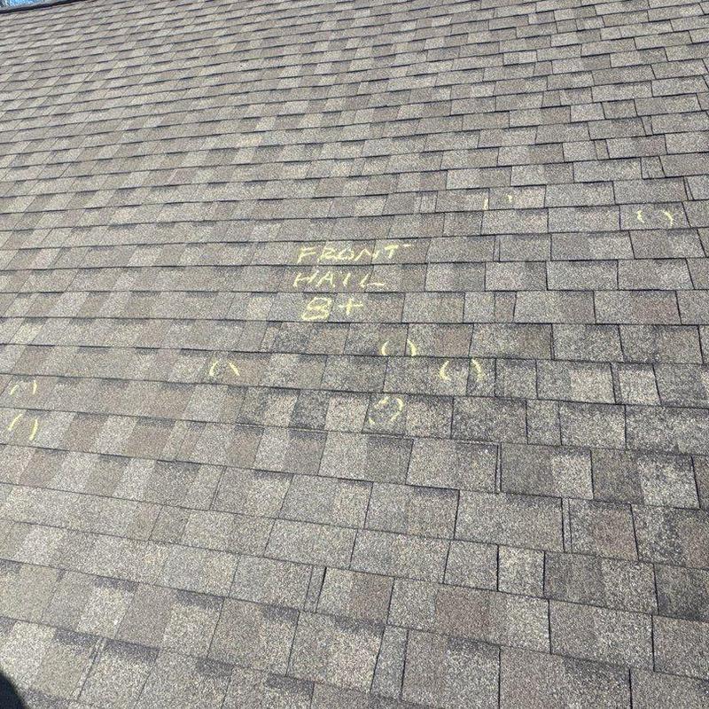 Asphalt shingle roof with marked hail damage inspection