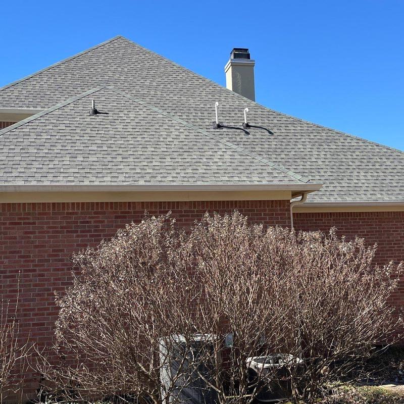 Asphalt shingle roof with vent pipes and chimney